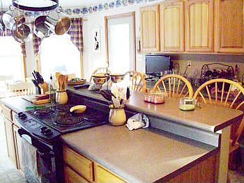 Hickory cabinets grace this large and inviting kitchen. Plenty of room for everyone to join in preparing family meals and holiday treats. There is no lack of counter space as well as a sit up counter for getting the kids breakfast before school.