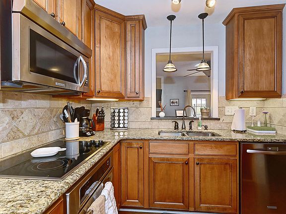 Double sink with stainless steel dishwasher. View into the living room.