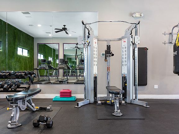 Fitness center with cardio and strength training equipment.