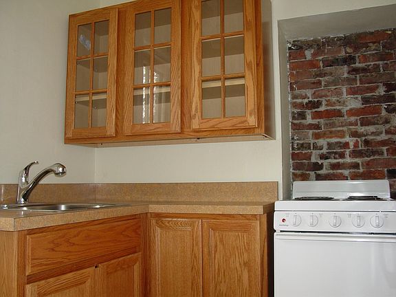Glass-fronted cabinets, deep sink and electric stove make cooking and clean up easy.