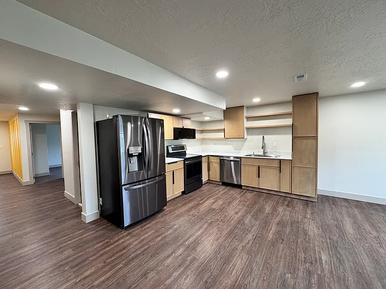 Modern kitchen with sleek cabinetry, open shelving, stainless steel appliances, and ample counter space_designed for both style and functionality.