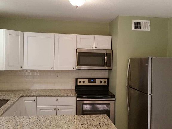 New granite counter-tops and stainless steel microwave, fridge, dishwasher and glass top range.