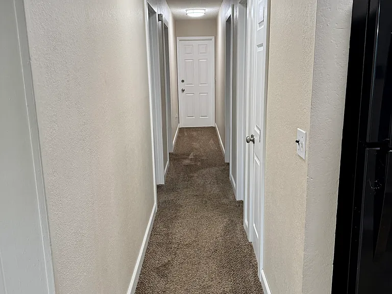 Hallway to 3 bedrooms and bathroom
