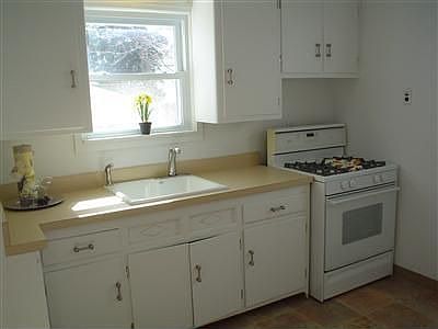 THE KITCHEN BOASTS NEW FLOORING AND IS FRESHLY PAINTED. 
