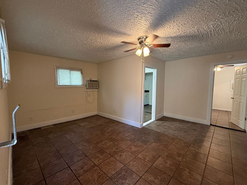 Open living and dining space, mostly tile floors