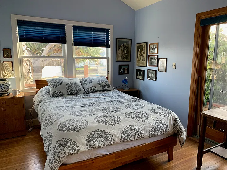 Back bedroom. Queen bed. Sliding glass door to back yard.