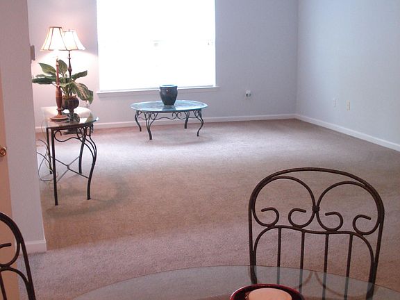 Living room and dining space. Dining table with 4 chairs can remain in unit or be removed.