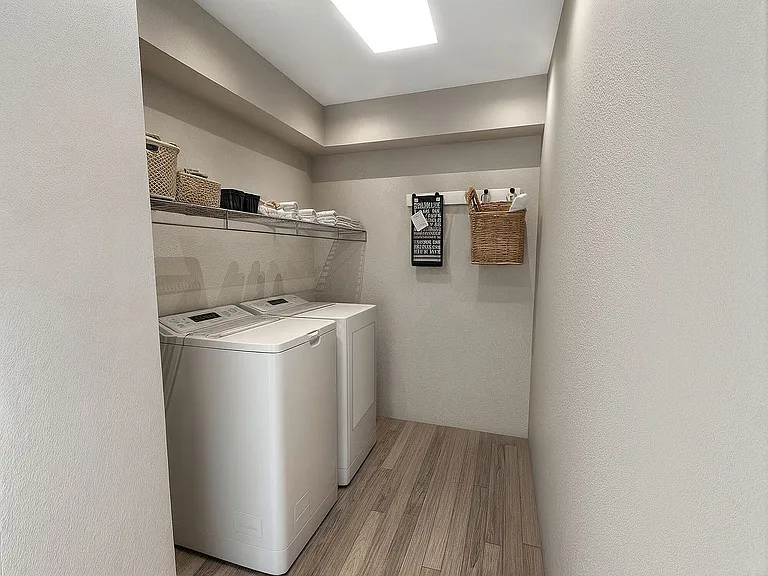 Laundry room with built in storage and hardwood style flooring