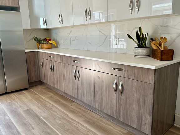 Freshly renovated kitchen, new stainless steel Samsung appliances, side by side refrigerator, new stove, new floors.