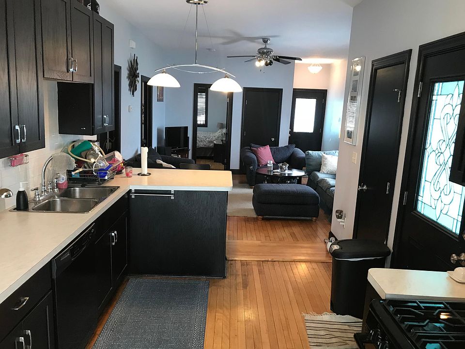 Kitchen looking into living room toward front of house.