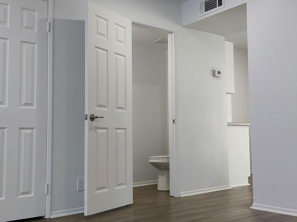 LIVING ROOM: Guest Closet, Guest Half-Bathroom & entrance to Kitchen