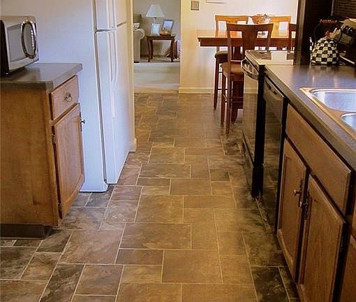 This is a very cool Kitchen!  It boasts NEW easy-care vinyl flooring, countertops, backsplash, sink & appliances and is situated right in between the Living Room and Family Room - what a great layout!