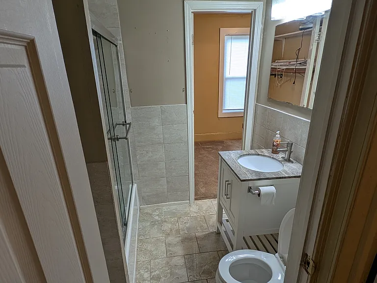 Tiled Bathroom with Granite Sink Top.