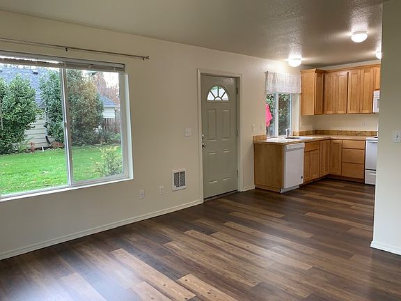 Standing in the living room, looking into the kitchen