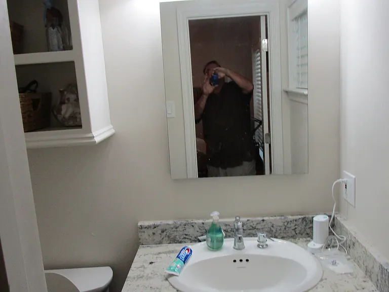 Front bathroom sink. Has medicine cabinet for storage.