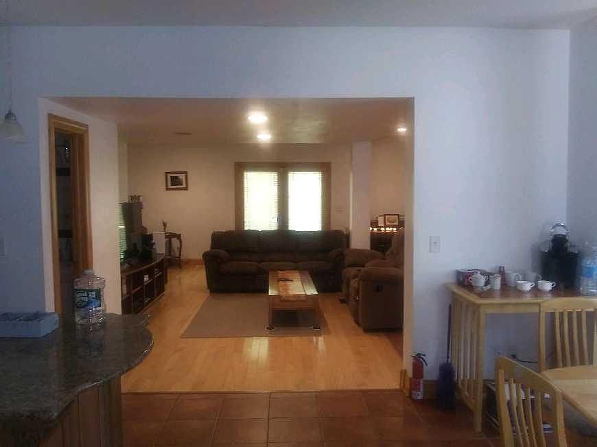 Eat-in Kitchen, 1st of 3 Bathrooms, Living Room, 55" Television, Wifi Stereo, Sofa Bed, Double Recliner + DayBed with a Trundle Twin beneath. French Door Access to 65' x 45' Furnished Green Space
