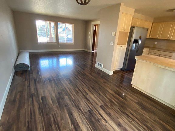 A expanse living area for both the couches and a large fromal dinning table as well as seating at the kitchen bar.