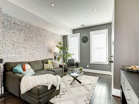 Charming living room with white washed exposed brick.