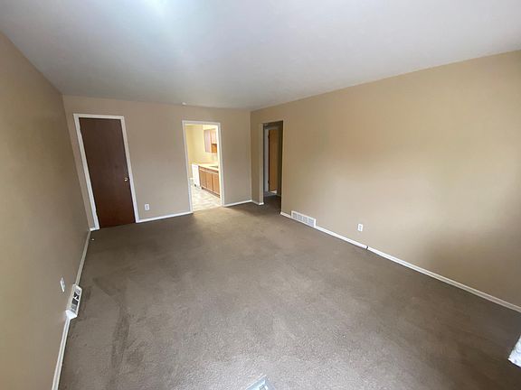 Closet in Living Room with Beige Carpet