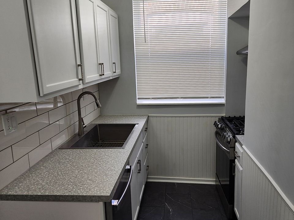 One side of the kitchen with brand new floors, counter tops, stainless steel appliances including Stove, Fridge, Dishwasher