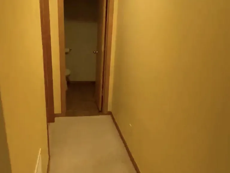 Hallway to half bath from 4th bedroom in basement
