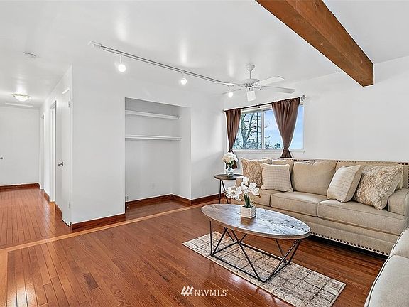 Living room is large & show cases 2nd option for tv or a cute space for a  work station with room for a desk and shelving above.