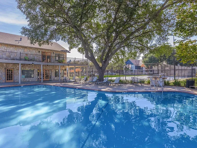 Experience the serene lifestyle at Distinction Apartment Homes, featuring a stunning pool surrounded by lush landscaping. Enjoy relaxation and community in a vibrant setting. Schedule your tour today and elevate your living experience!