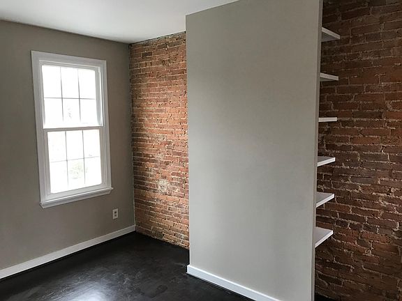Exposed brick bedroom wall