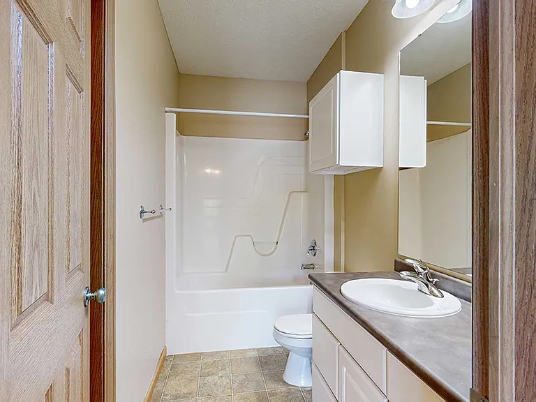 Our bathrooms feature a sleek design with a full-size tub and shower, perfect for relaxing and refreshing.