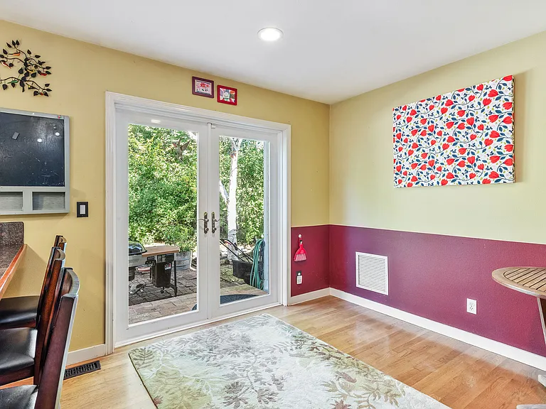 The eat-in nook opens out through French-doors to the backyard.