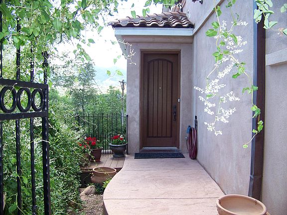 Private courtyard entry with summer foliage