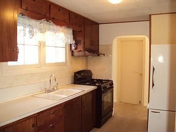 The kitchen includes the stove and refrigerator.