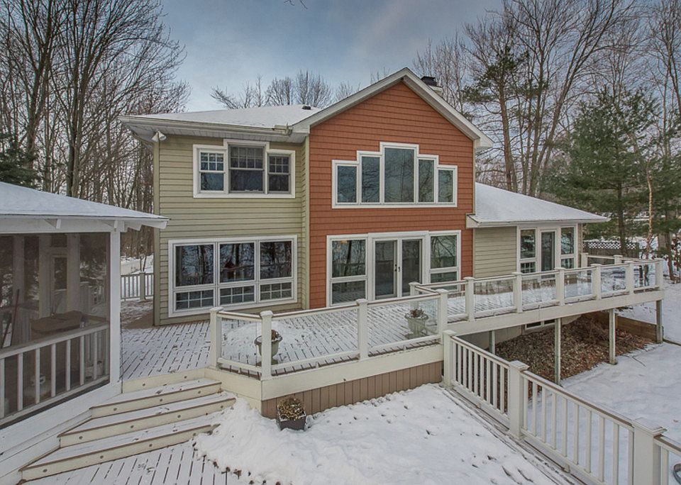 Exceptional Waterfront Retreat on Sanford Lake! Private, wooded setting on 1.78 Acres with 129 feet 