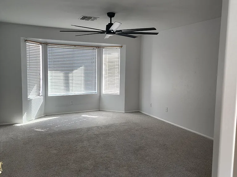 Master bedroom with 72 inch fan, bay window