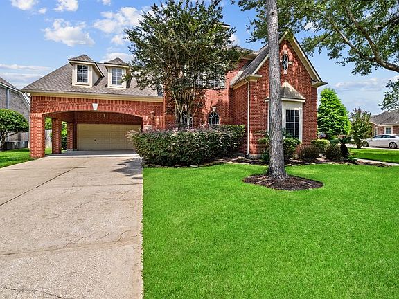The long double-wide driveway provides ample parking space for visitors.