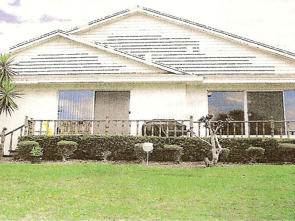 Back, with deck, overlooks a peaceful pond