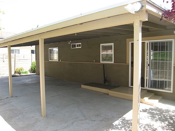 Full Length Covered Patio along Back of House w/Laundry Hookups (Center under Middle Window)