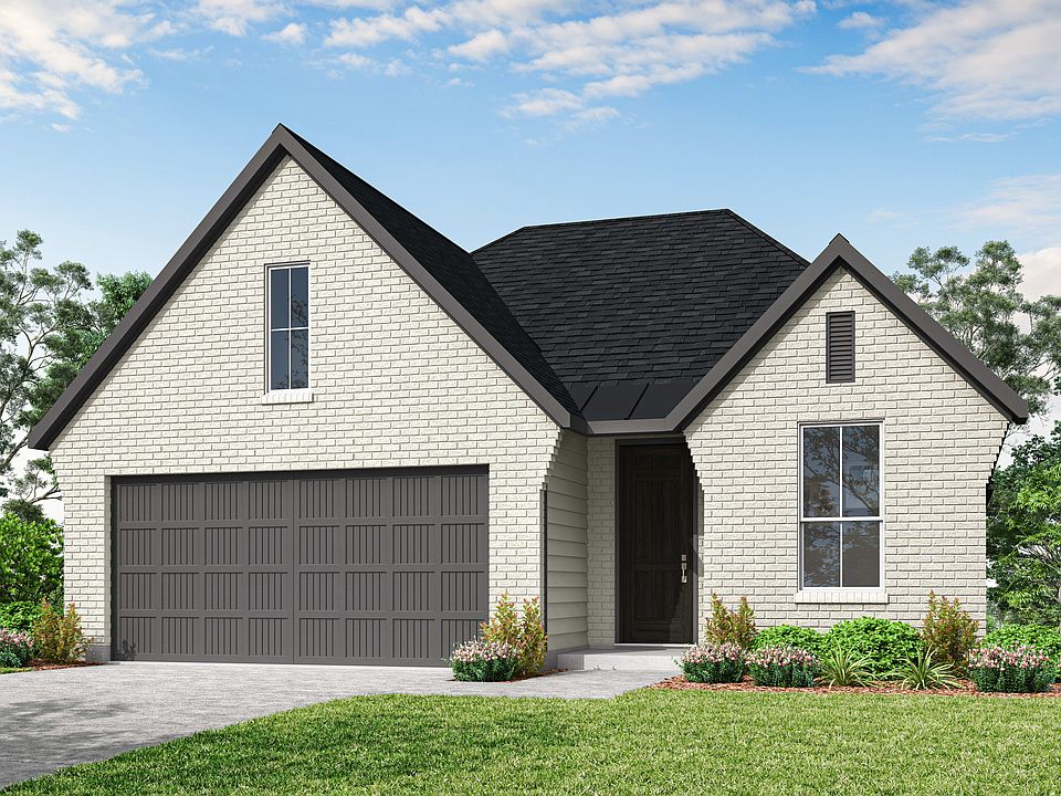 A two-story house with a garage, surrounded by lush greenery and a clear blue sky with fluffy clouds