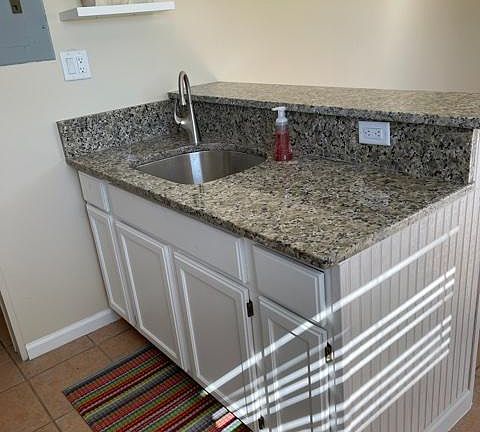 New granite countertop with new stainless steel under-mount kitchen sink and kitchen faucet.