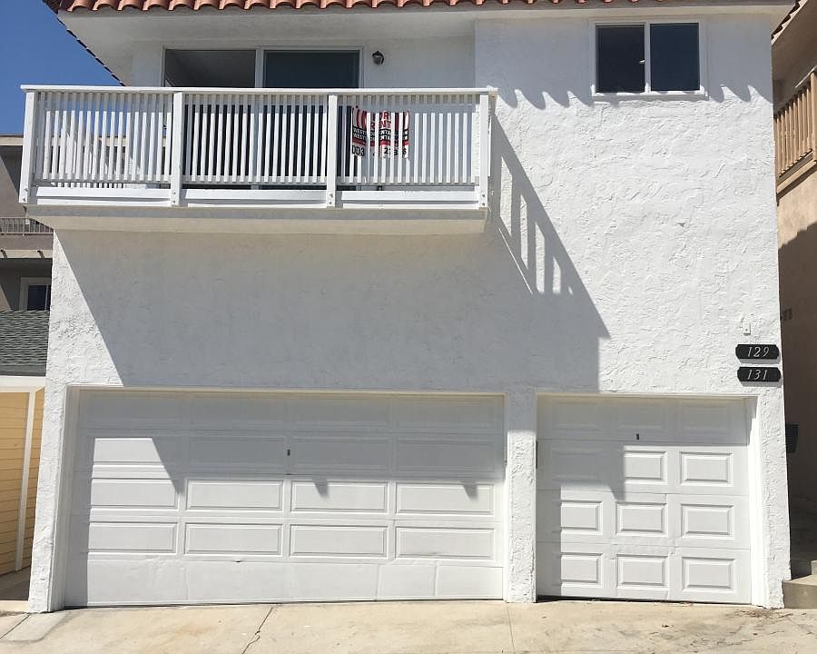 photo of duplex, 2 garage and 2 parking spots. Rare in the Sand Section.