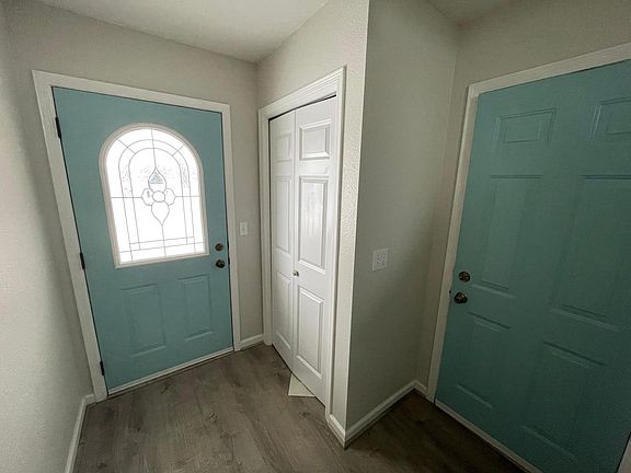 Front door and side garage door entry with large coat closet with shelving