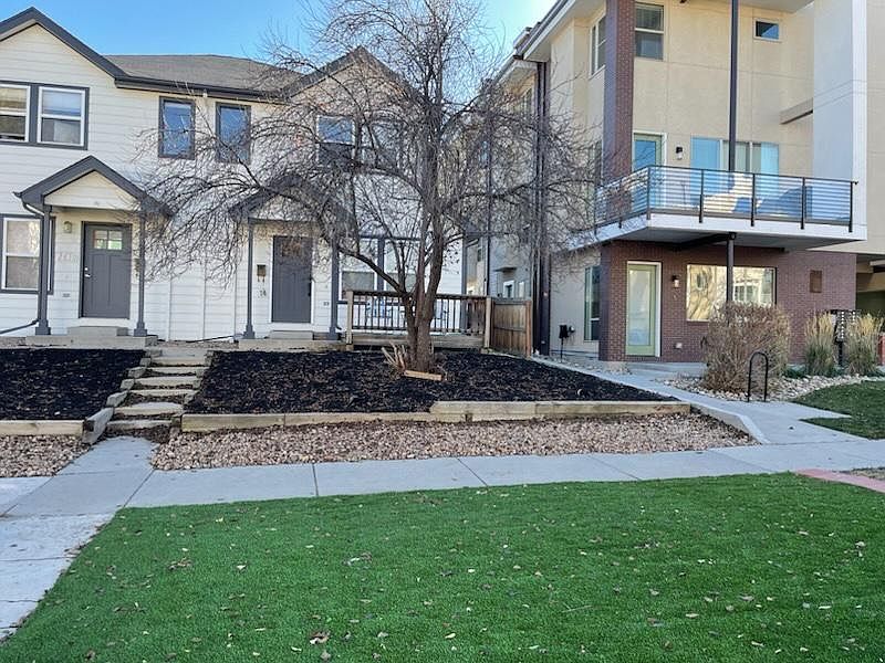 Front yard recently zero-scarped with mulch, rock & artificial turf.