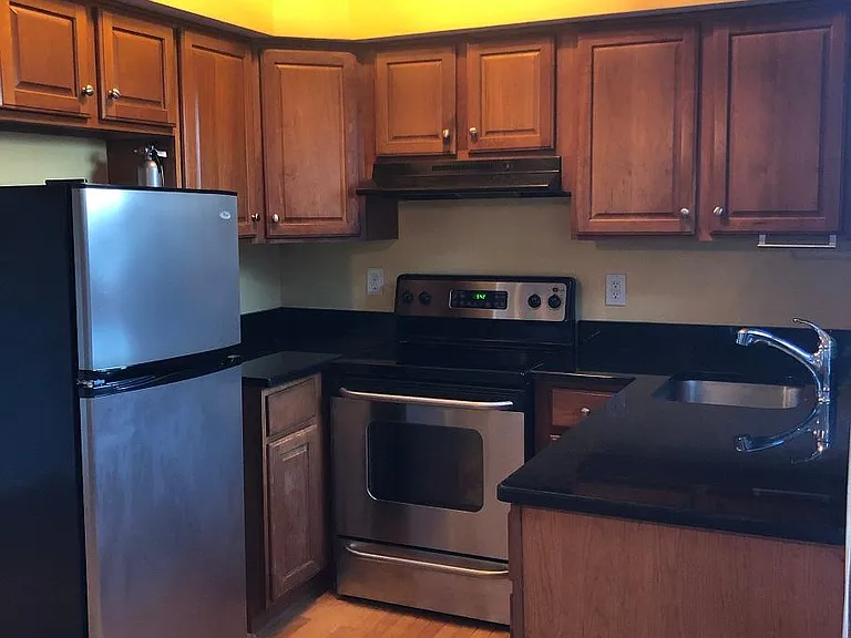 Kitchen. Copper pot rack above with hooks and platform saves space, keeps pots handy and looks cool!