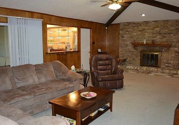 Large living room with wet bar and wood-burning fireplace.