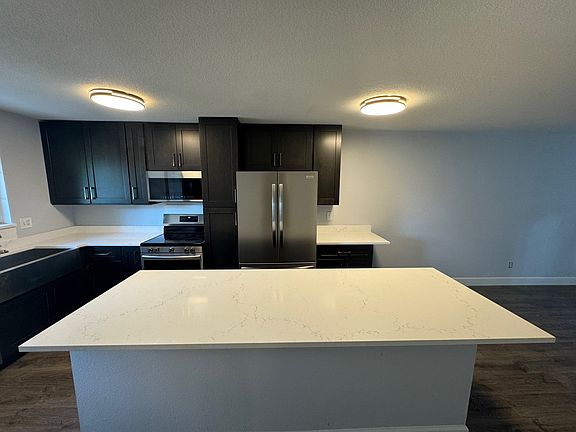 Island kitchen with space for prep and dining seating.