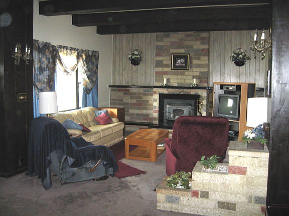 Large living room w/ wbfp features wood beamed ceiling