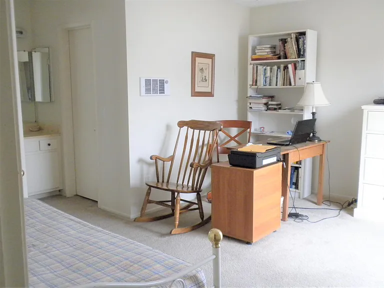 2nd Level - Second bedroom is spacious to have a daybed, office desk and drawers. It has walk-in closet; vanity/sink; laminate flooring. This picture was taken before the laminate flooring was installed. [Excludes all furnishings]