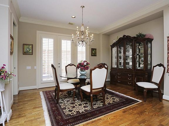 Another view of the dining room, features include plantation shutters, wood floors and double crown 