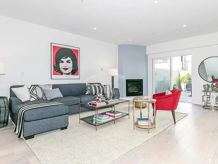 Spacious living room, exit to 600sf deck, and a gas fireplace.