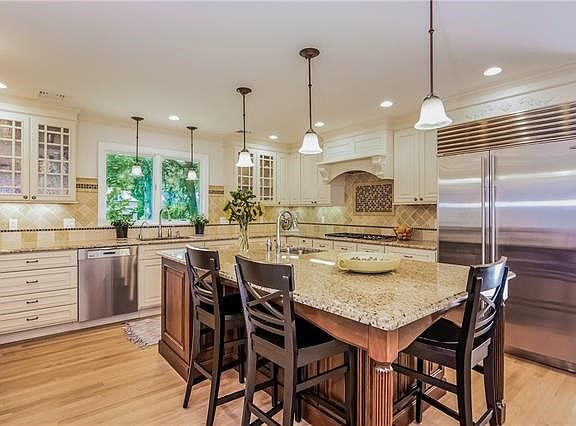 The eat-in kitchen also has custom cabinets, double wall oven and two dishwashers